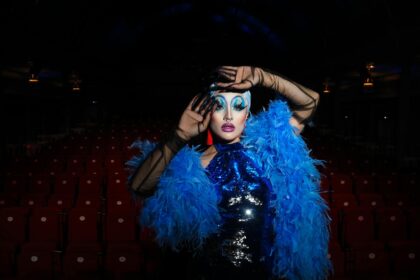 woman in eccentric costume posing in theater